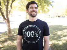 Load image into Gallery viewer, Young man wearing a black shirt with “100%” on the front to represent our commitment to being a 100% non-profit to fight human trafficking