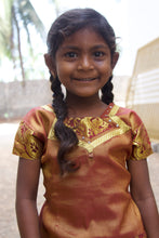 Load image into Gallery viewer, Little Indian girl with a brown shirt rescued from slavery or human trafficking