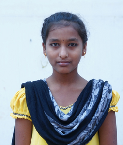Little Indian girl rescued from slavery or human trafficking with a yellow shirt and blue shawl
