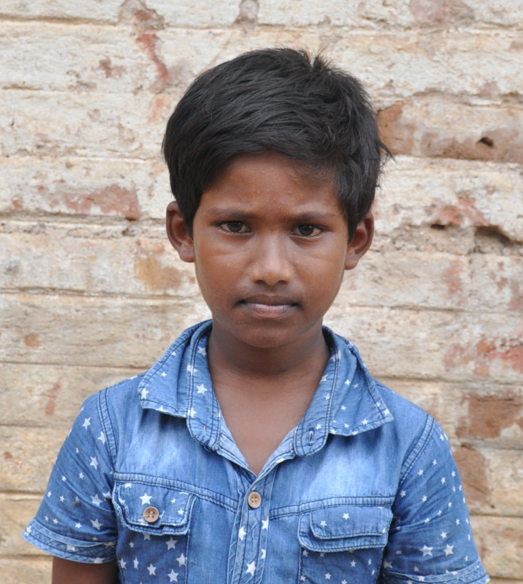 Little Indian boy with a blue shirt rescued from slavery or human trafficking