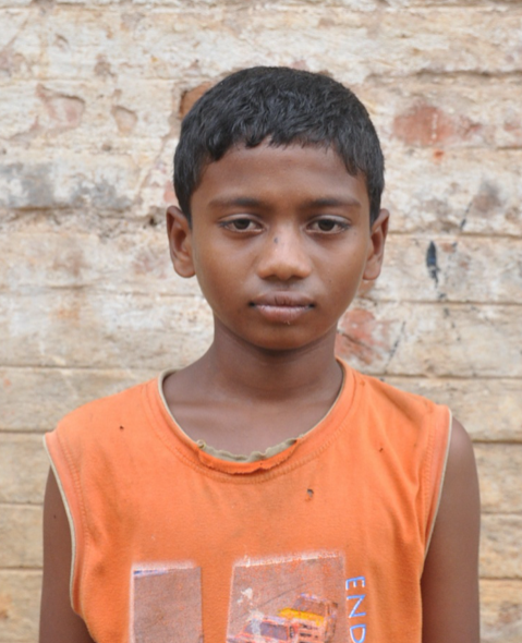 Little Indian boy with a orange shirt rescued from slavery or human trafficking
