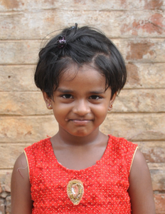 Little Indian girl with a red shirt rescued from slavery or human trafficking