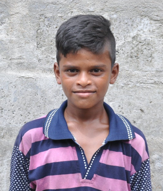 Little Indian boy with a blue and pink polo rescued from slavery or human trafficking
