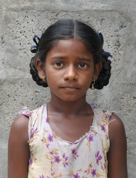 Little Indian girl with a white shirt rescued from slavery or human trafficking