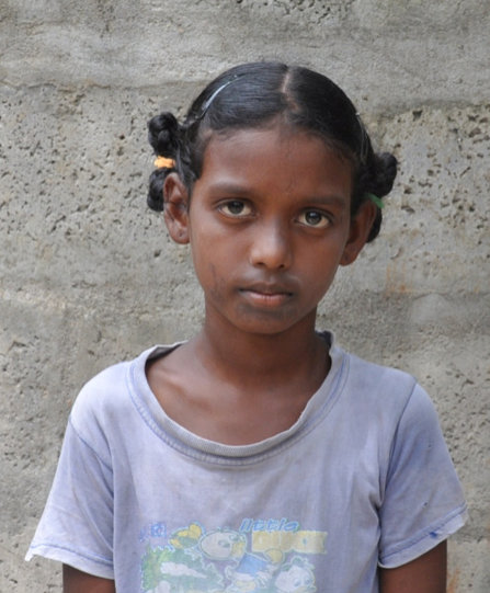 Little Indian girl with a grey shirt rescued from slavery or human trafficking