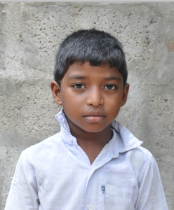 Little Indian boy with a light blue shirt rescued from slavery or human trafficking