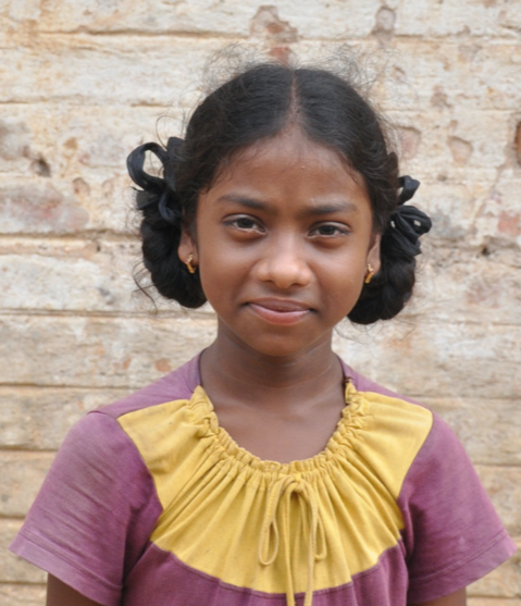 Little Indian girl with a purple yellow shirt rescued from slavery or human trafficking