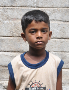 Little Indian boy with a tan shirt rescued from slavery or human trafficking