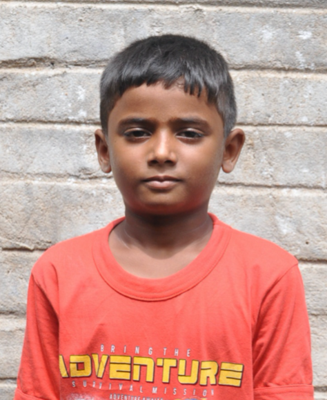 Little Indian boy with a red shirt rescued from slavery or human trafficking