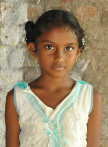 Little Indian girl with a white shirt rescued from slavery or human trafficking