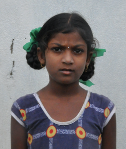 Little Indian girl with a blue shirt rescued from slavery or human trafficking