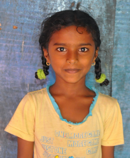 Little Indian girl with a yellow shirt rescued from slavery or human trafficking