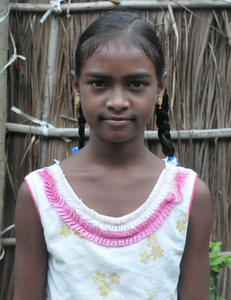 Little Indian girl with a white shirt rescued from slavery or human trafficking