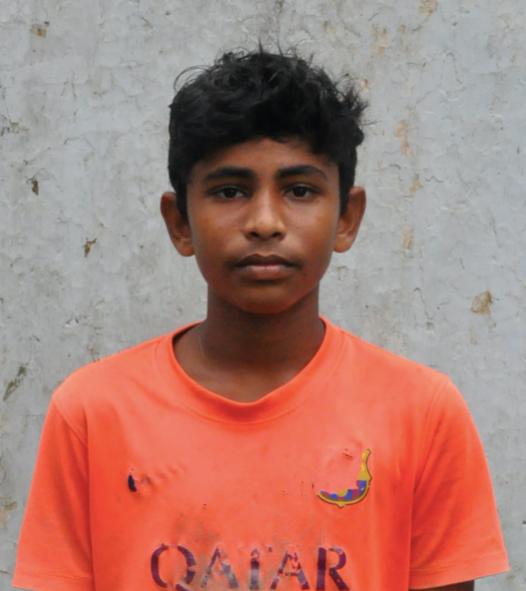 Young Indian male freed from human trafficking or slavery wearing orange and in need of scholarship support and sponsorship