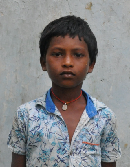 Little Indian boy with a white shirt rescued from slavery or human trafficking