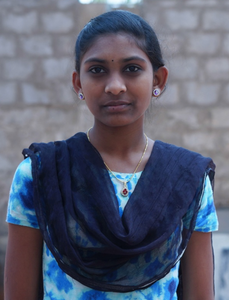 Little Indian girl rescued from slavery or human trafficking with a light blue shirt