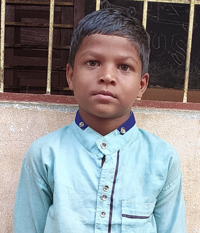Little Indian boy with a light blue shirt rescued from slavery or human trafficking