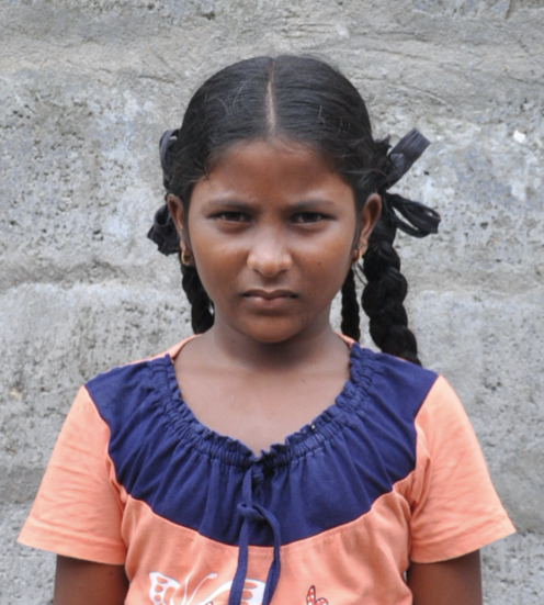 Little Indian girl with a pink and blue shirt rescued from slavery or human trafficking