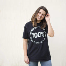 Load image into Gallery viewer, Young woman wearing a black shirt with “100%” on the front to represent our commitment to being a 100% non-profit to fight human trafficking